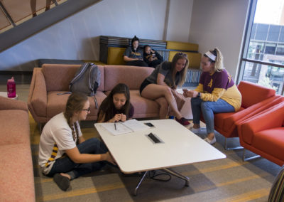A group of young women students hang out in the communal space