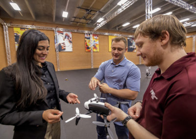 Stephanie Gil stands with two students in the ASU Drone Studio
