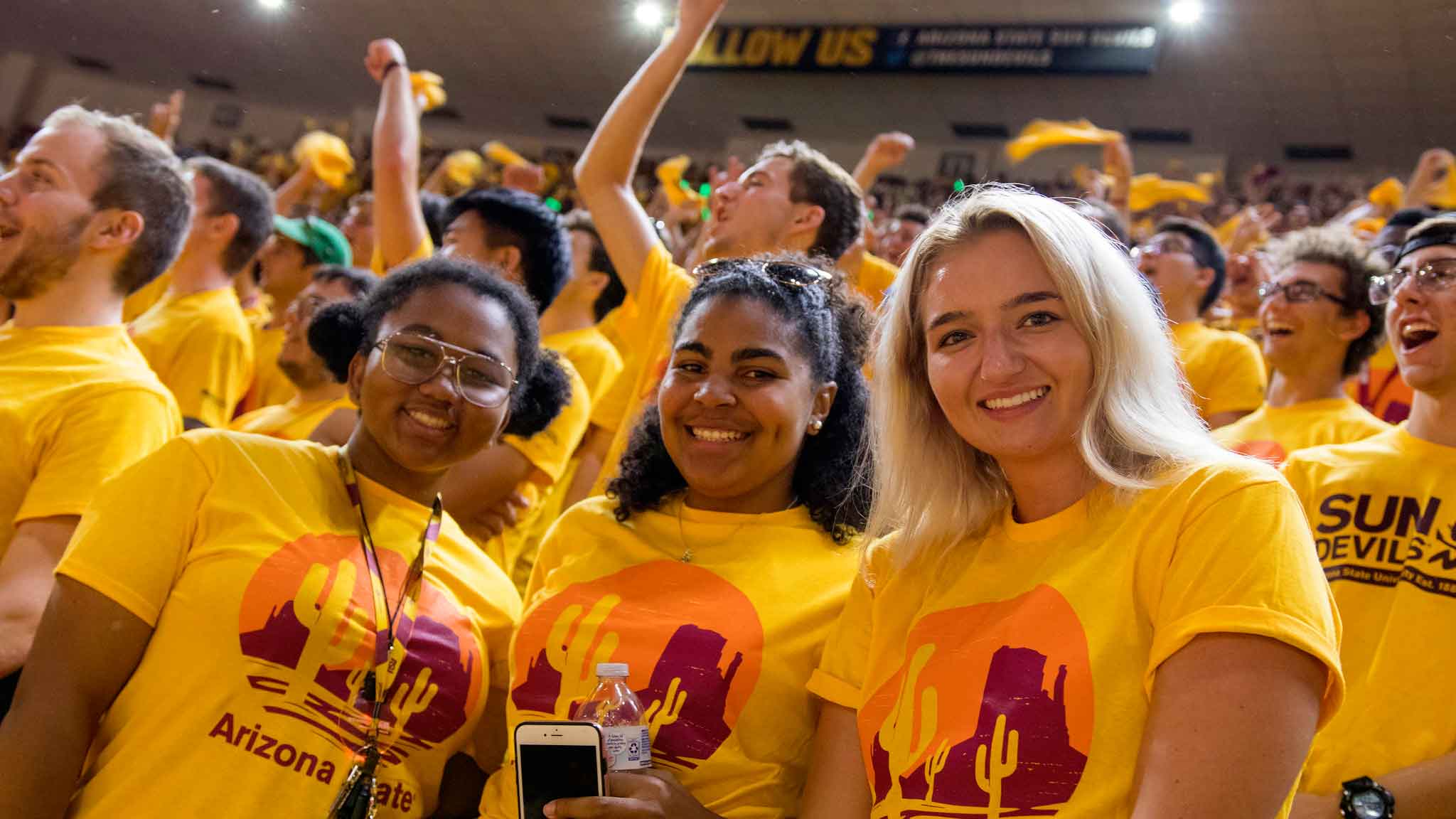 Three women in the huge crowd at the Fall Welcome smile for the camera
