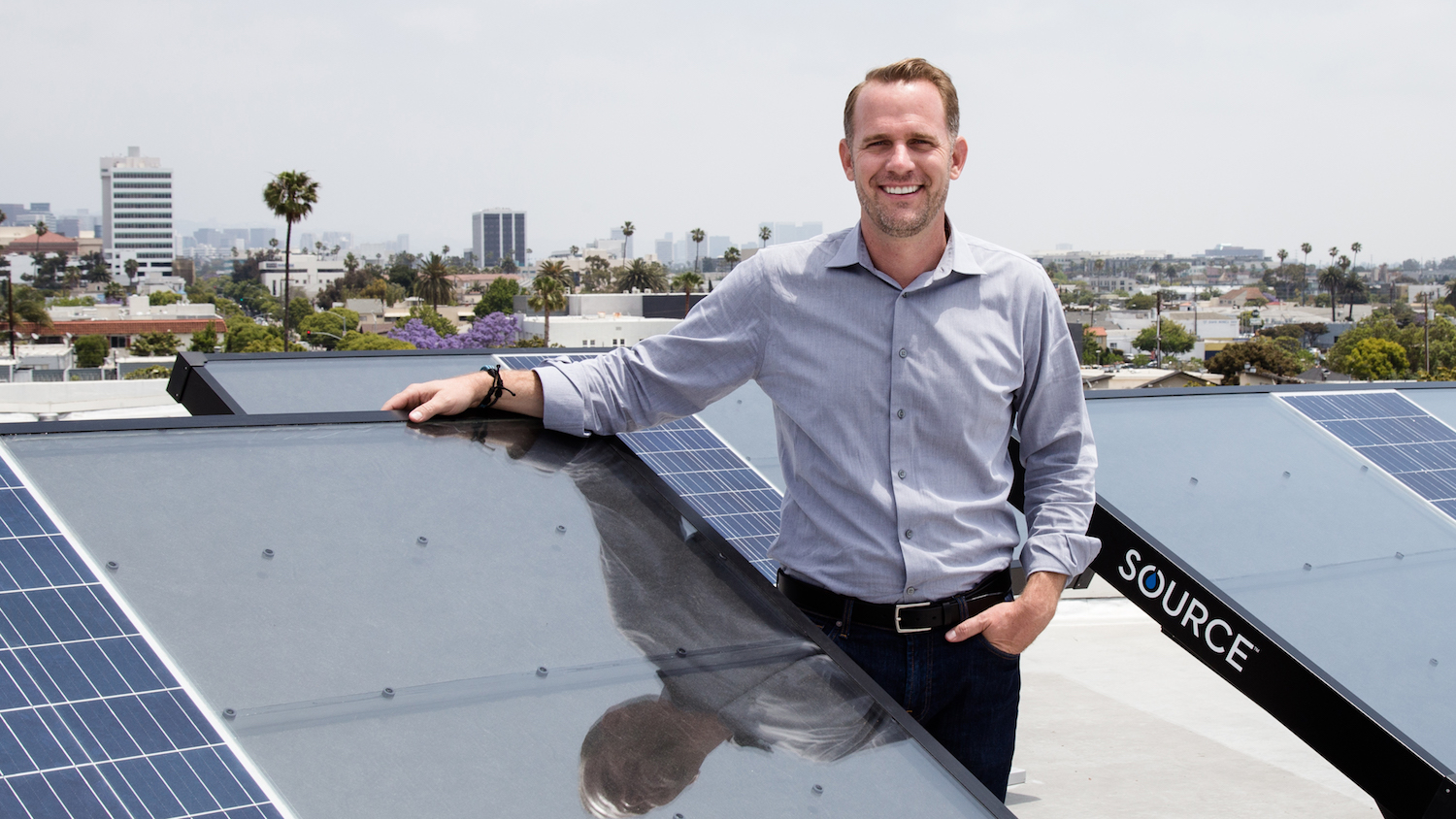 Cody Friesen stands on a roof among several SOURCE hydropanels, which extract clean water from the air using only solar power. Friesen invented the panels and won the 2019 Lemelson-MIT Prize for this and other inventions for the developing world.