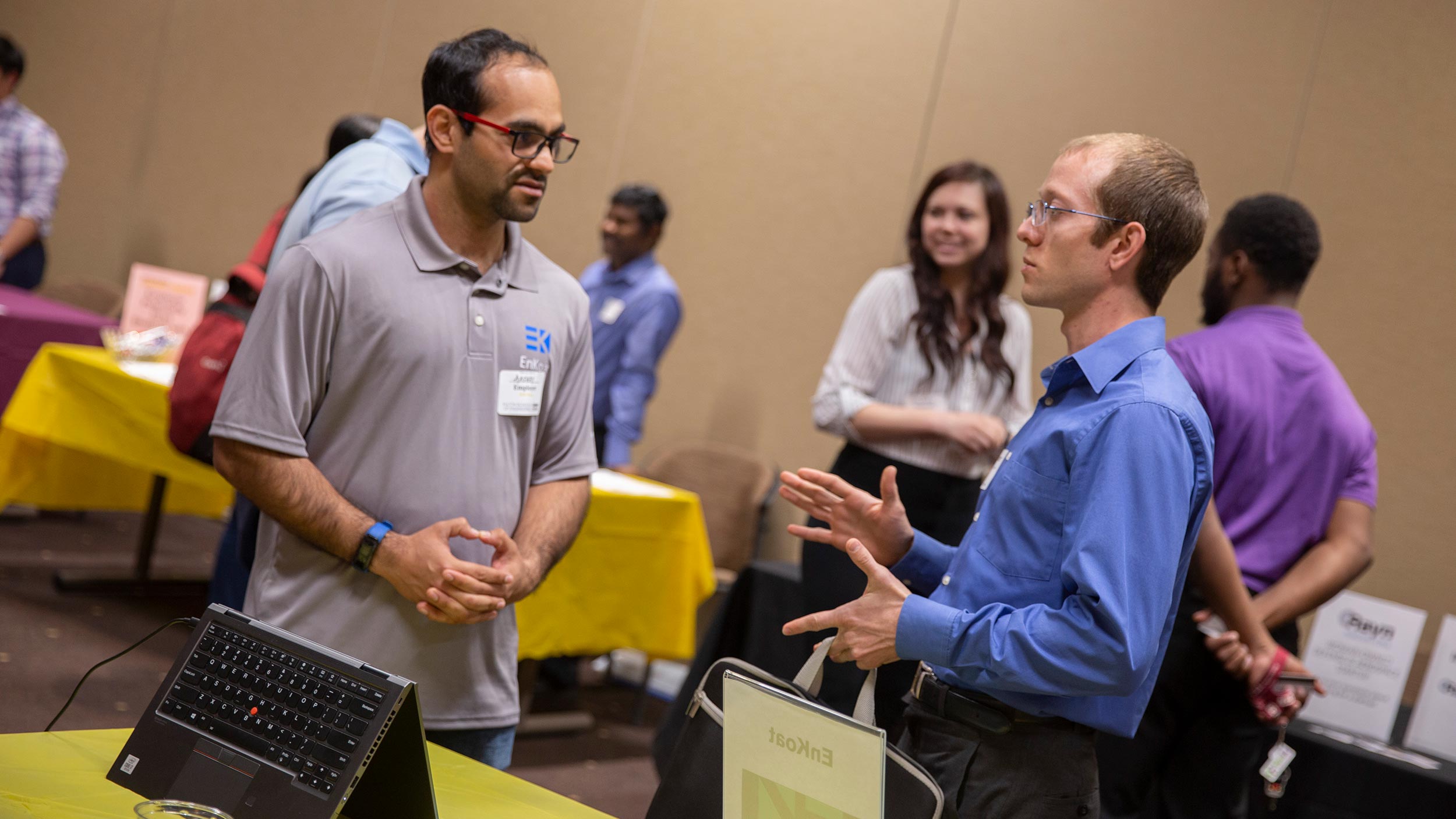 Man speaking to another man at a career fair