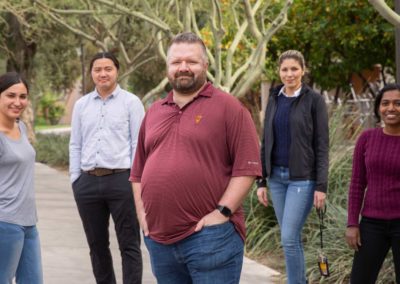 Christian Hoover stands on campus with members of his lab