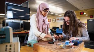 Two female engineers collaborate on a project.