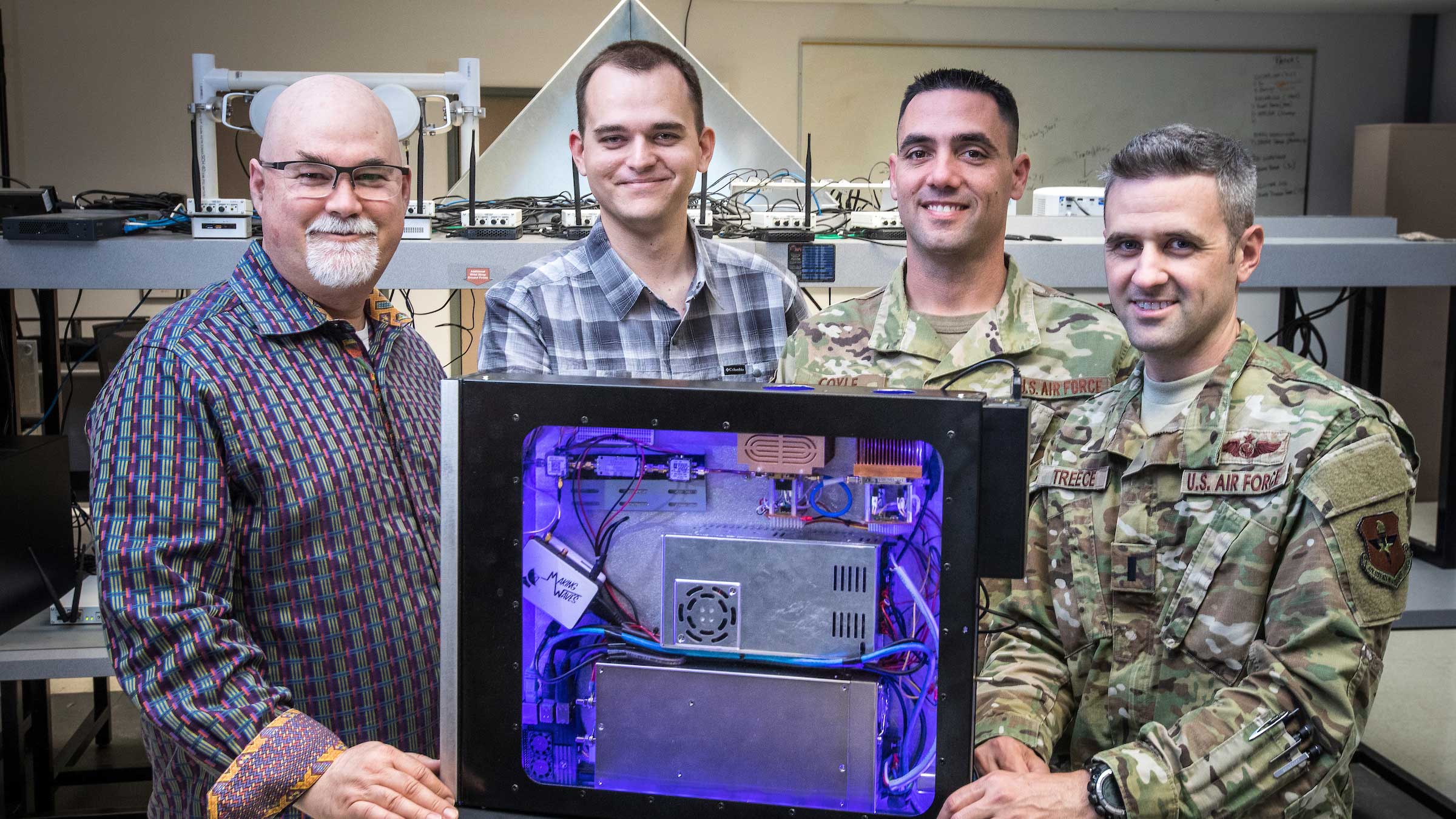Dan Bliss and the three other members of the Making Waves team stand with their proof-of-concept threat emitter, DUMTE