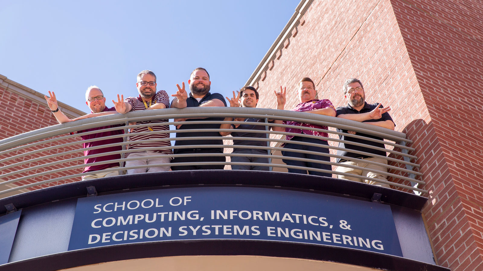 6 members of the CIDSE IT team stand on a balcony
