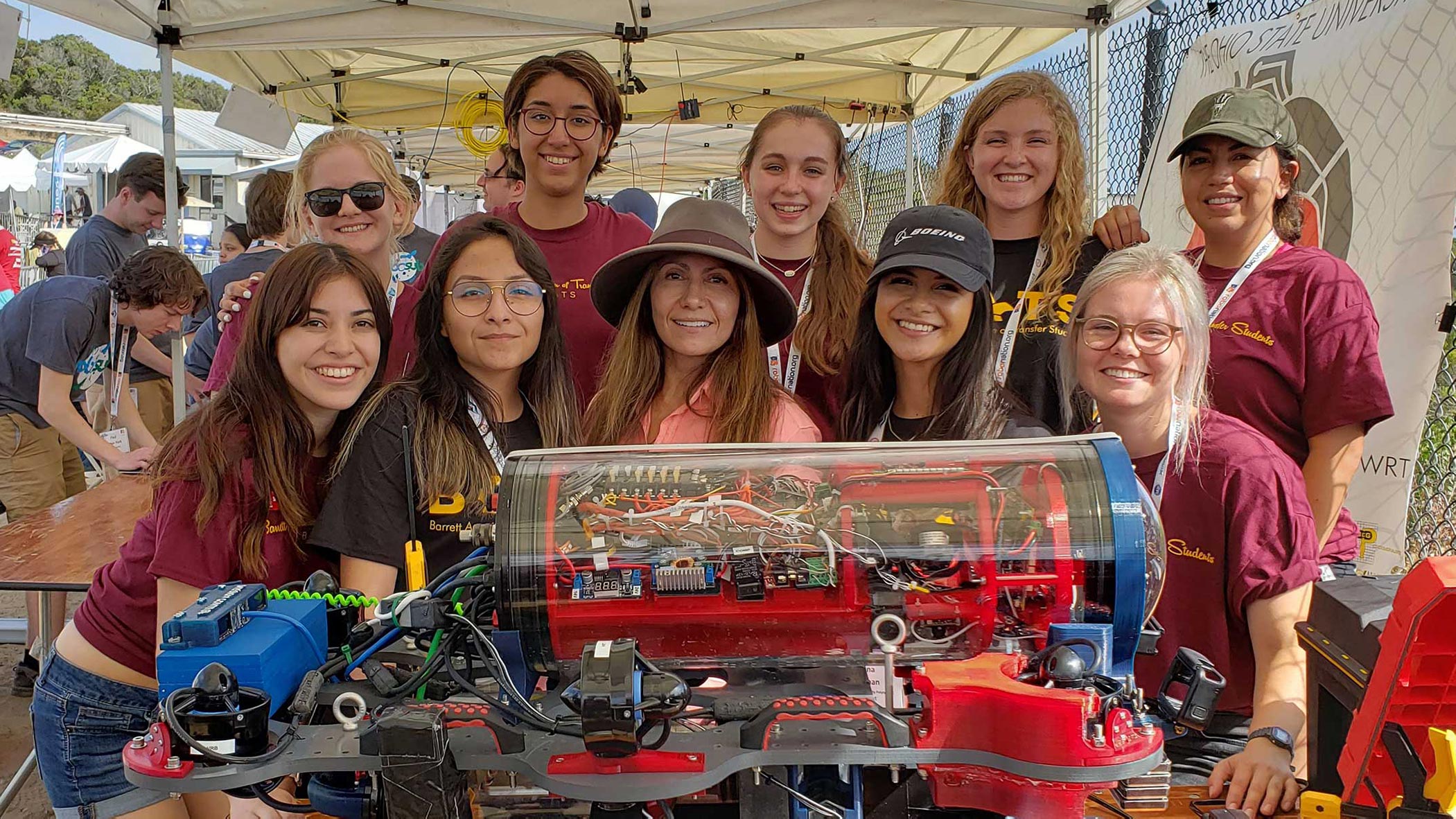 The all-women Desert WAVE underwater robotics team poses for a team photo with their robot