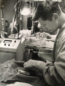 black and white photo of Keith Larsen working in lab