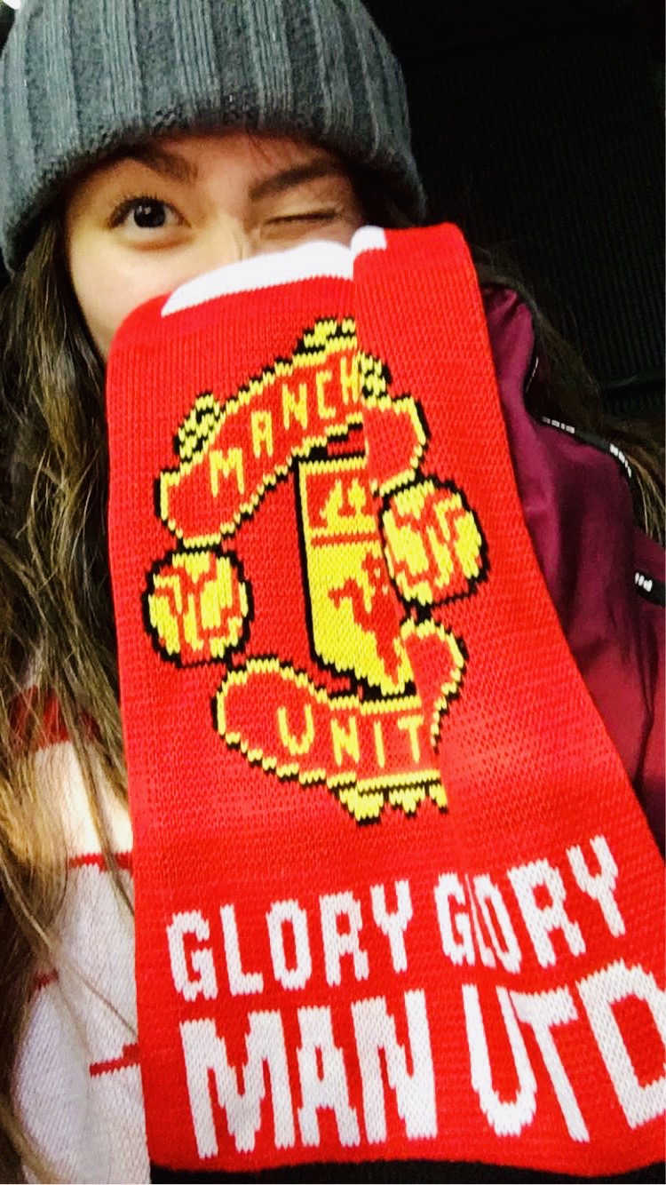 Victoria Dong wearing a Manchester United football team scarf