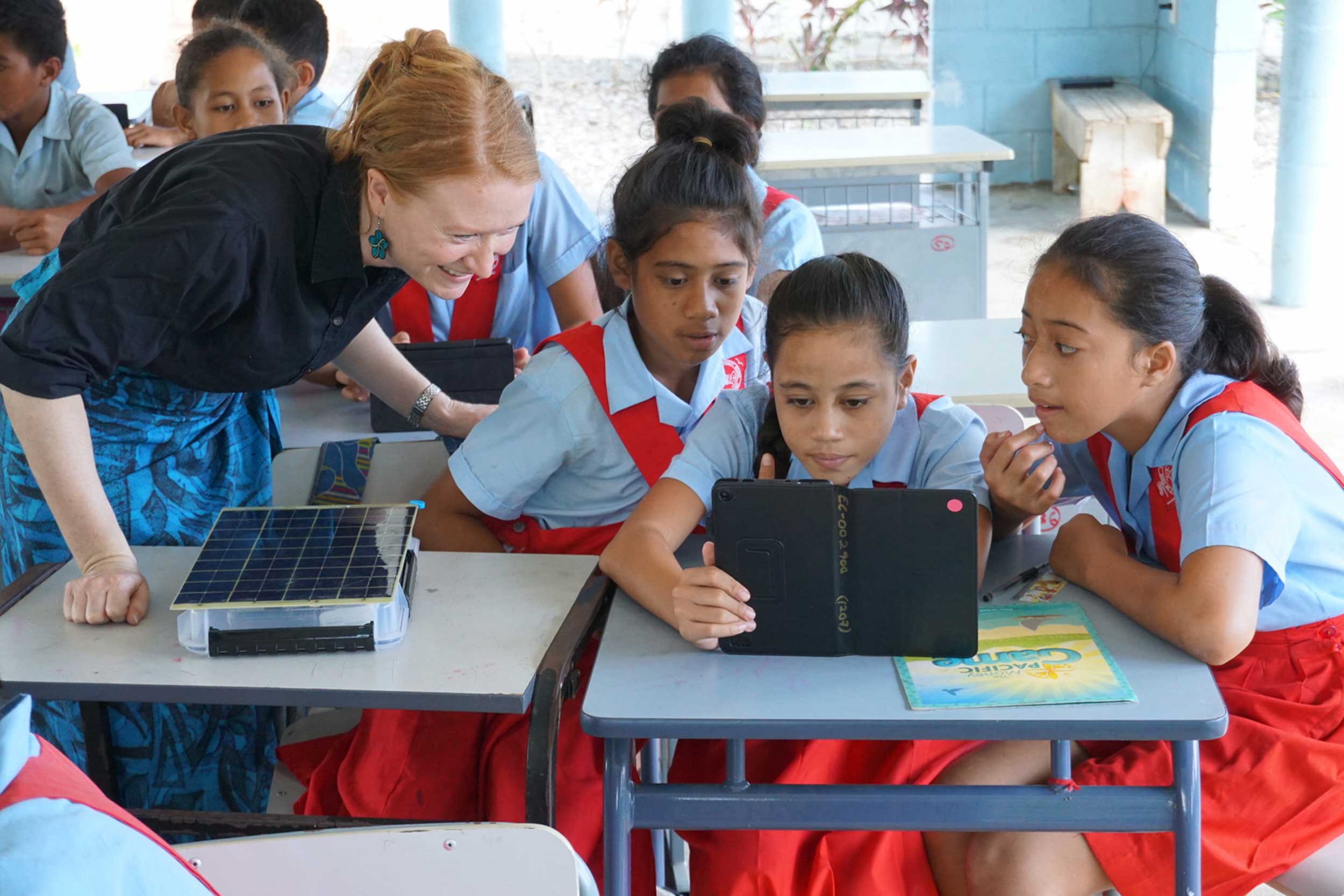 Laura Hosman, creator of SolarSPELL, works with girls in Samoa