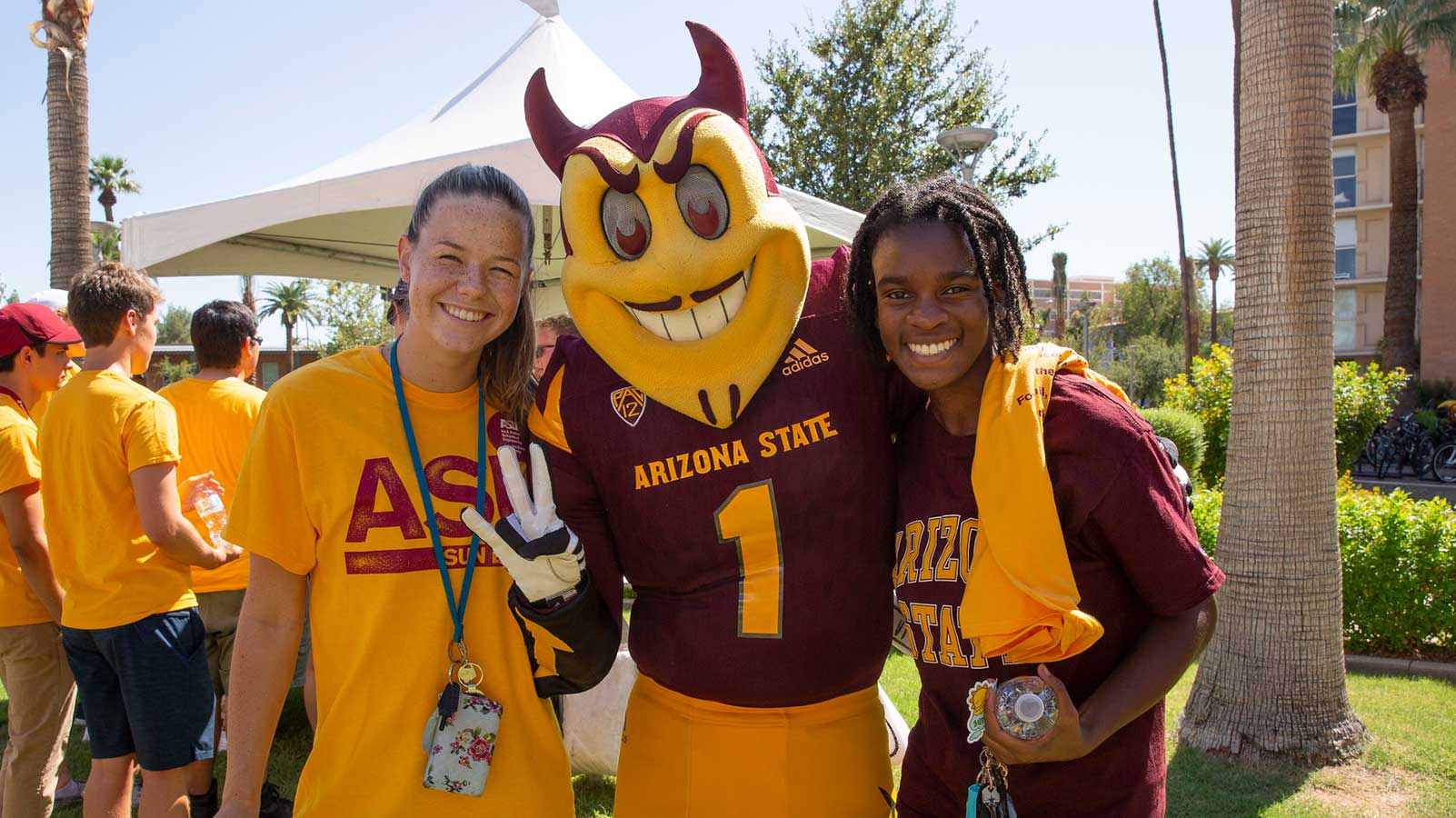 Two students pose with Sparky