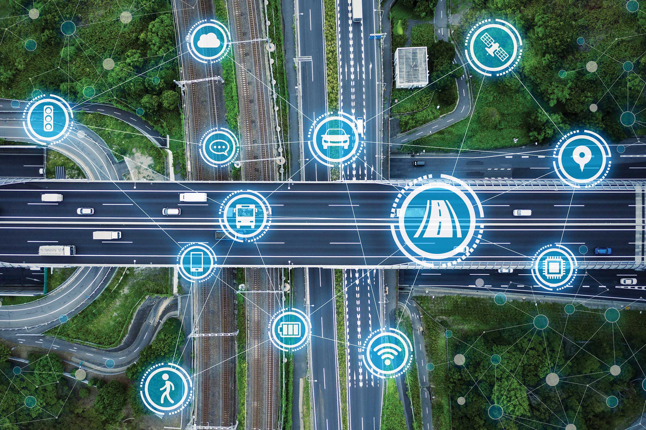 Stylized stock aerial view of a motorway intersection superimposed with connectivity icons, such as wifi and speech bubbles
