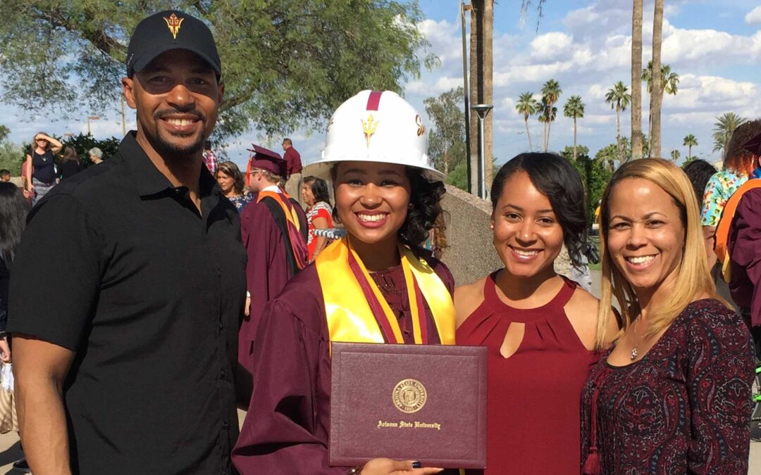 Nicole Evans stands with her family at her graduation in 2017.