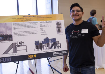Elvis Leon, member of HeliosRocketry, presents the student team's research during a poster symposium.