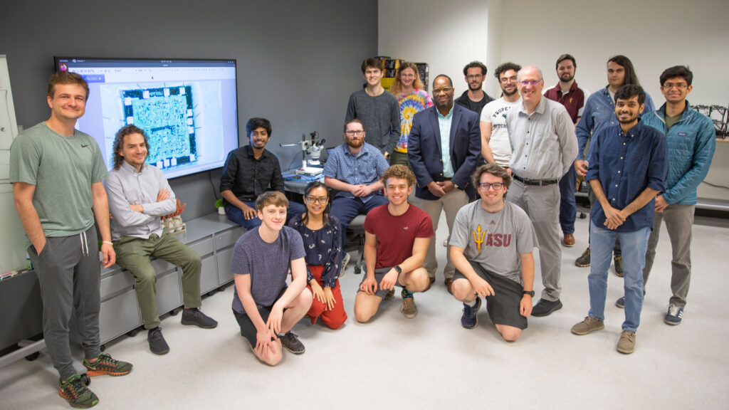 Group photo of Michael Kinsey and 17 other ASU STAM Center researchers in the lab