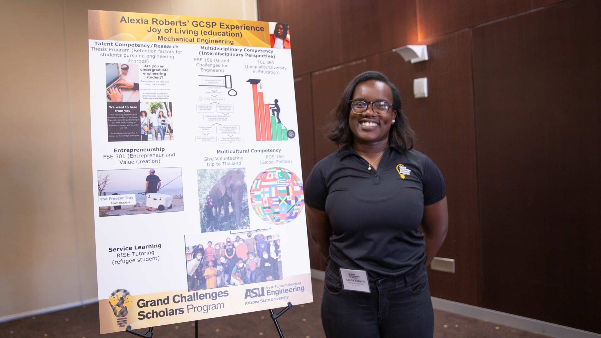Alexia Roberts, an African-american scholar, poses happily by her poster displaying her research