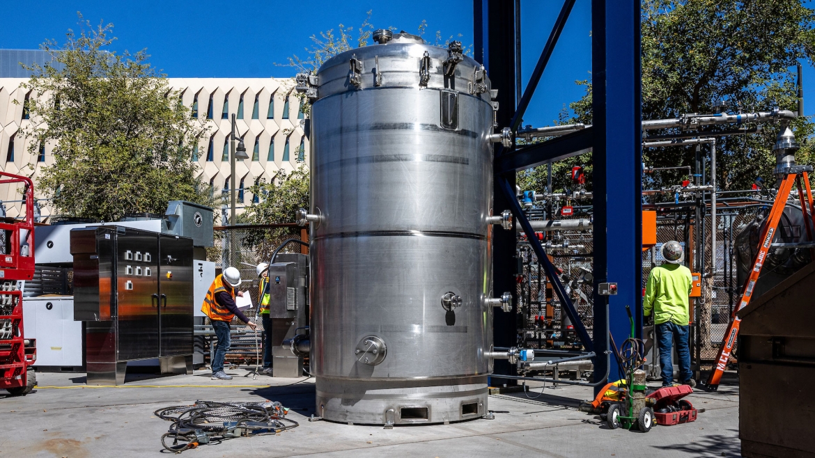 Technicians run pressure checks on the MechanicalTree on March 8 during its installation near the Biodesign C building on ASU's Tempe campus. The large canister forms the base of the tree; when it is fully extended, a column of disks holding "leaves" of a special sorbent material will remove carbon dioxide from passing air to combat global warming at scale. 