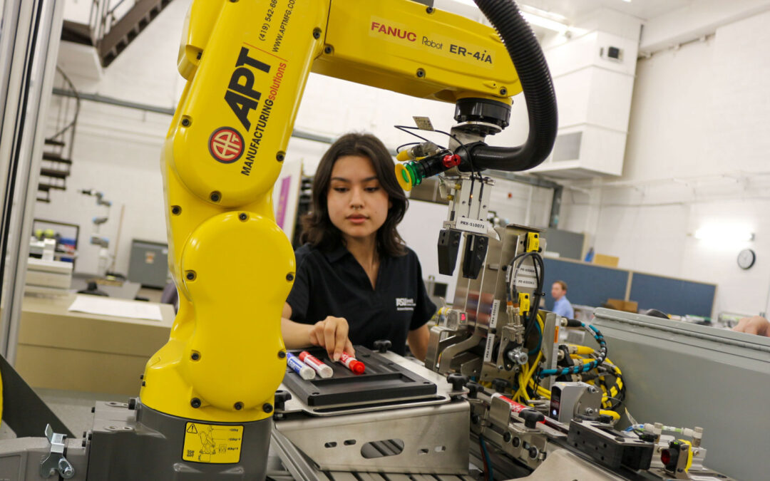 A student operates a large machine.